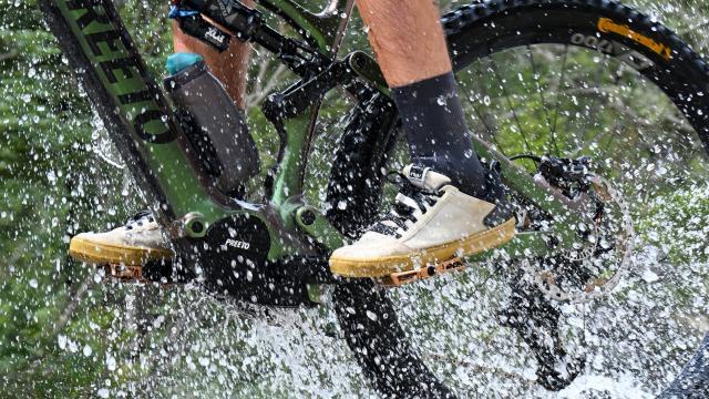 Biker in splashing water